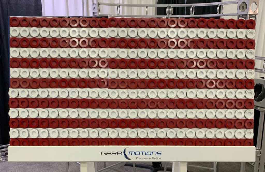 Ron Rafferty and RJ Rafferty of China Gear Motions stand with the custom made Chinese flag made out of gears at Dongguan Gear, Dongguan, Guangdong